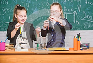 Inspire. Little girls scientist with microscope. Biology lab. Happy Genius. Little girls genius in school lab. Science