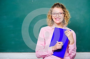 Inspire. teacher with document folder. girl teacher at school lesson. happy student in glasses at blackboard. report