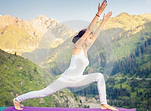 Inspired asian woman doing exercise of yoga at mountain range