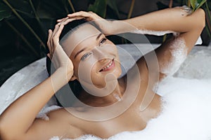 Inspired Bath and Body Care Treatment of Spa Woman in Bathtub