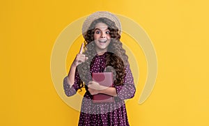 inspired with idea kid with frizz hair hold book on yellow background