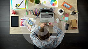 Inspired male creator writing down all his ideas on piece of paper to remember