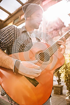 Inspired male guitarist becoming professional on street