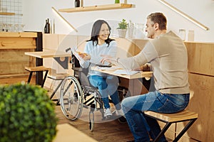 Inspired man and disabled woman discussing work