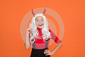 Inspired teenage child in imp horns. cheerful kid has an idea. feel the inspiration. carnival costume party. trick or