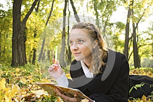 Inspired teenager girl in autumn park photo