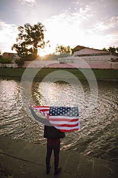 Inspired US patriot holds national flag outdoor