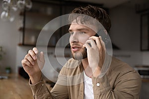 Inspired young man explain idea to business partner by phone