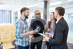 Inspired young people discussing new project in conference room