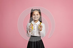 Inspiring education. Little child in school uniform with backpack smiles at camera