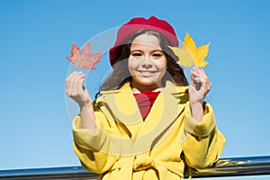 Inspiring fall. Ideas for autumn leisure. Little girl adore autumn season. Kid hold maple leaves. Small girl wear fall