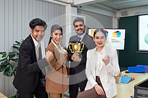 An inspiring image of a diverse cadre of business professionals, beaming with pride, as they pose with a coveted trophy in a