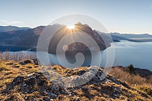 Inspiring scenery with rocks illuminated by the sunrise at Iseo Lake in Italy