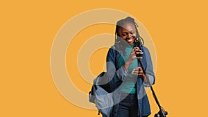 Inspiring woman using mic to present life lectures , studio background