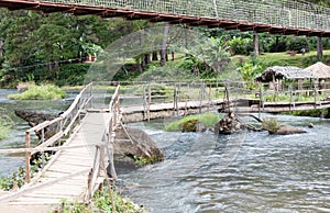 Instable old wooden bridge over a river
