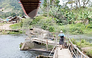 Instable old wooden bridge over a river