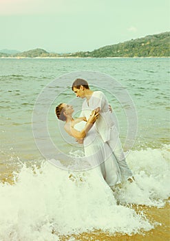 Instagram colorized vintage couple on beach portrait