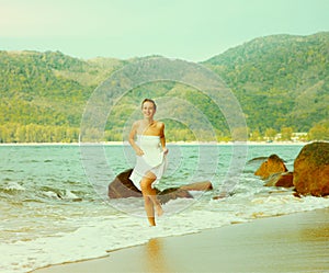 Instagram colorized vintage girl on beach portrait