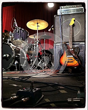 Instagram style image of a guitar and drums on stage