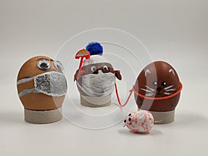 Installation, 3 Easter eggs wearing medical masks on a walk met a mouse.