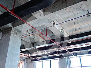 Installation of air conditioner ducting and chiller pipes system and hung it at the concrete slab.