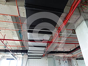 Installation of air conditioner ducting and chiller pipes system and hung it at the concrete slab.