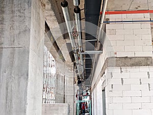 Installation of air conditioner ducting and chiller pipes system and hung it at the concrete slab.