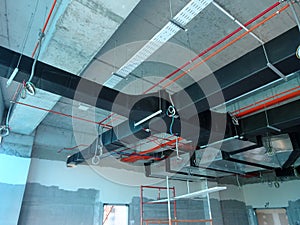 Installation of air conditioner ducting and chiller pipes system and hung it at the concrete slab.