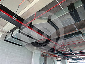 Installation of air conditioner ducting and chiller pipes system and hung it at the concrete slab.