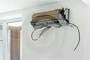 Installation air conditioning system in room with white wall in apartment, office closeup