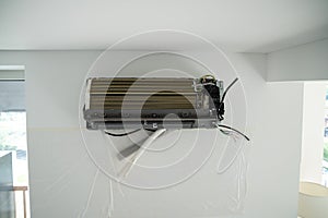 Installation air conditioning system in room with white wall in apartment, office closeup