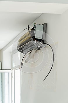 Installation air conditioning system in room with white wall in apartment, office closeup