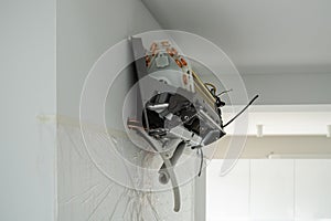 Installation air conditioning system in room with white wall in apartment, office closeup
