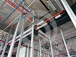 Installation of airconditioner ducting and chiller pipes system and hung it at the concrete slab.