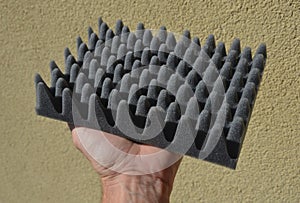 installation of anti-noise foam tiles is demonstrated by