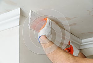 Installation of ceiling moldings.