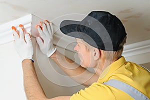 Installation of ceiling moldings.