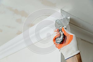 Installation of ceiling moldings.