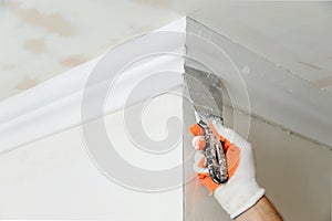 Installation of ceiling moldings.