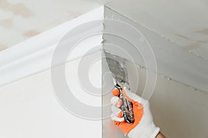 Installation of ceiling moldings.