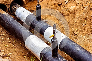 Installation of the distribution unit of heating and water supply network. Frame for connecting pipes in the trench of ground.