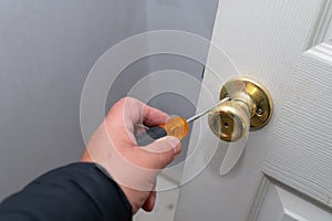 installation of the door lock, a locksmith hand close up