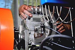 Installation of a fuel pump for a diesel engine after repair on an adjustment stand in a workshop, repair of a fuel pump,