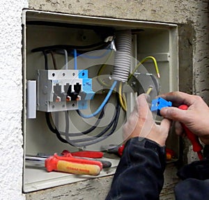Installation Of A Fuse Box. Working Hands. Cables and Breakers