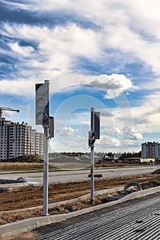 Installation of group traffic lights during the construction of a new traffic intersection and a pedestrian crossing at the edge