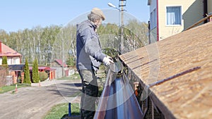 Installation of a gutter. Roofing works in a private house.