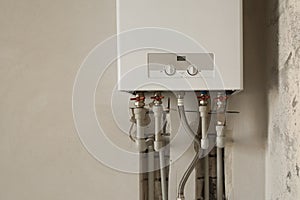Installation of home gas heating boiler with red taps