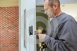 Installation interior door woodworker hands install lock