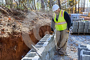 During installation of a large block retaining wall on construction site contractor was installing new wall