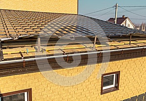 Installation of metal drain on the roof of the house